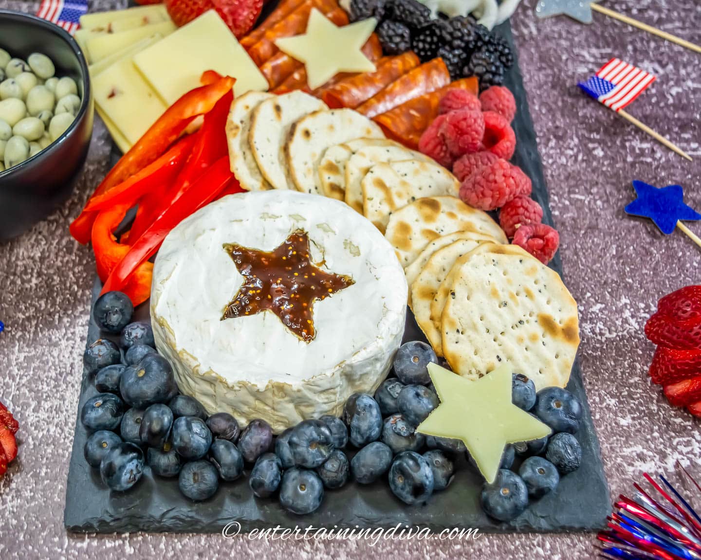 A red, white and blue charcuterie board on an outdoor table