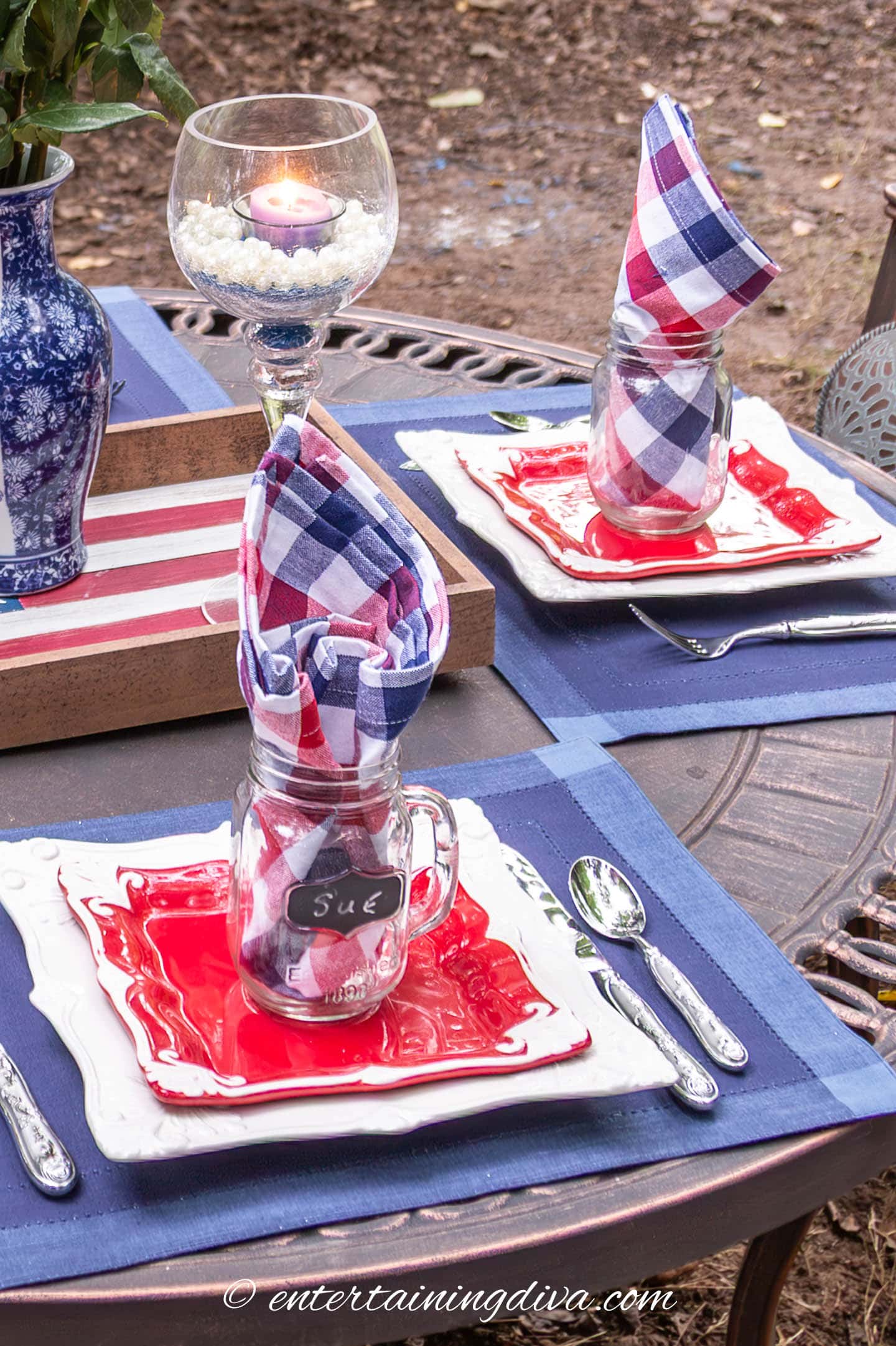 An outdoor table set with a red, white and blue table setting