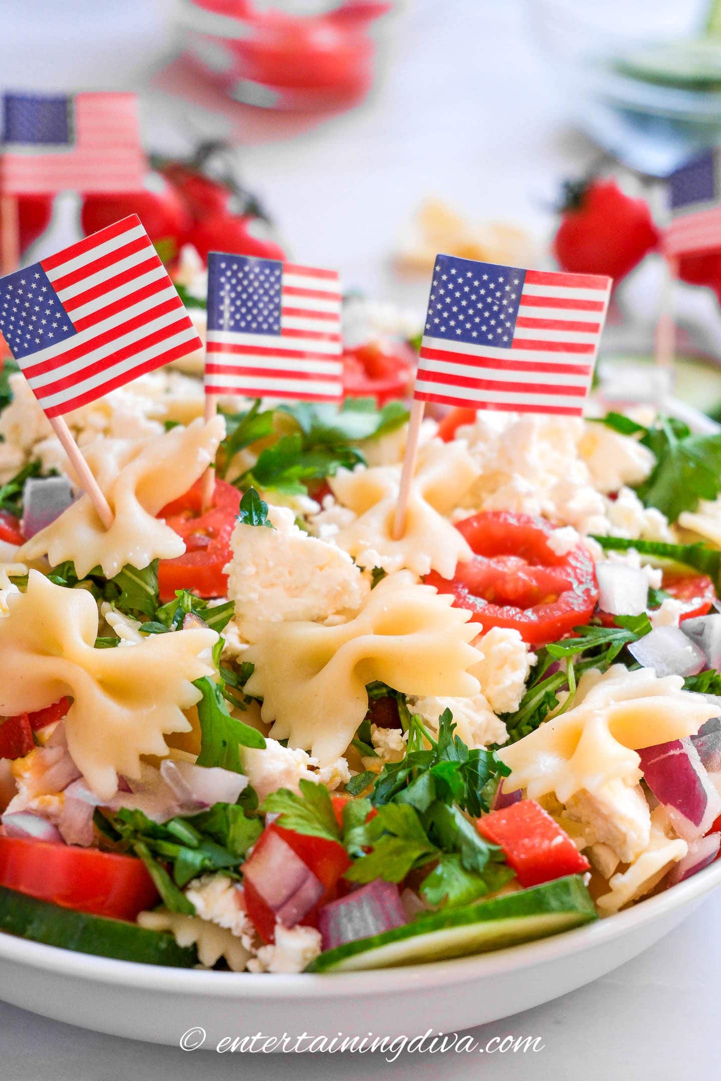 American flag toothpicks on top of a bowl of pasta salad