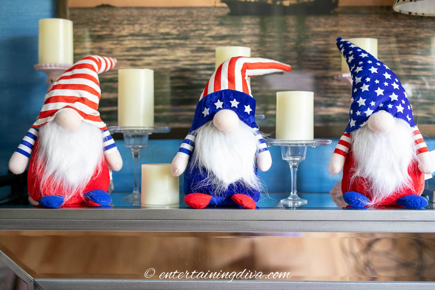3 4th of July gnomes on a table with candles