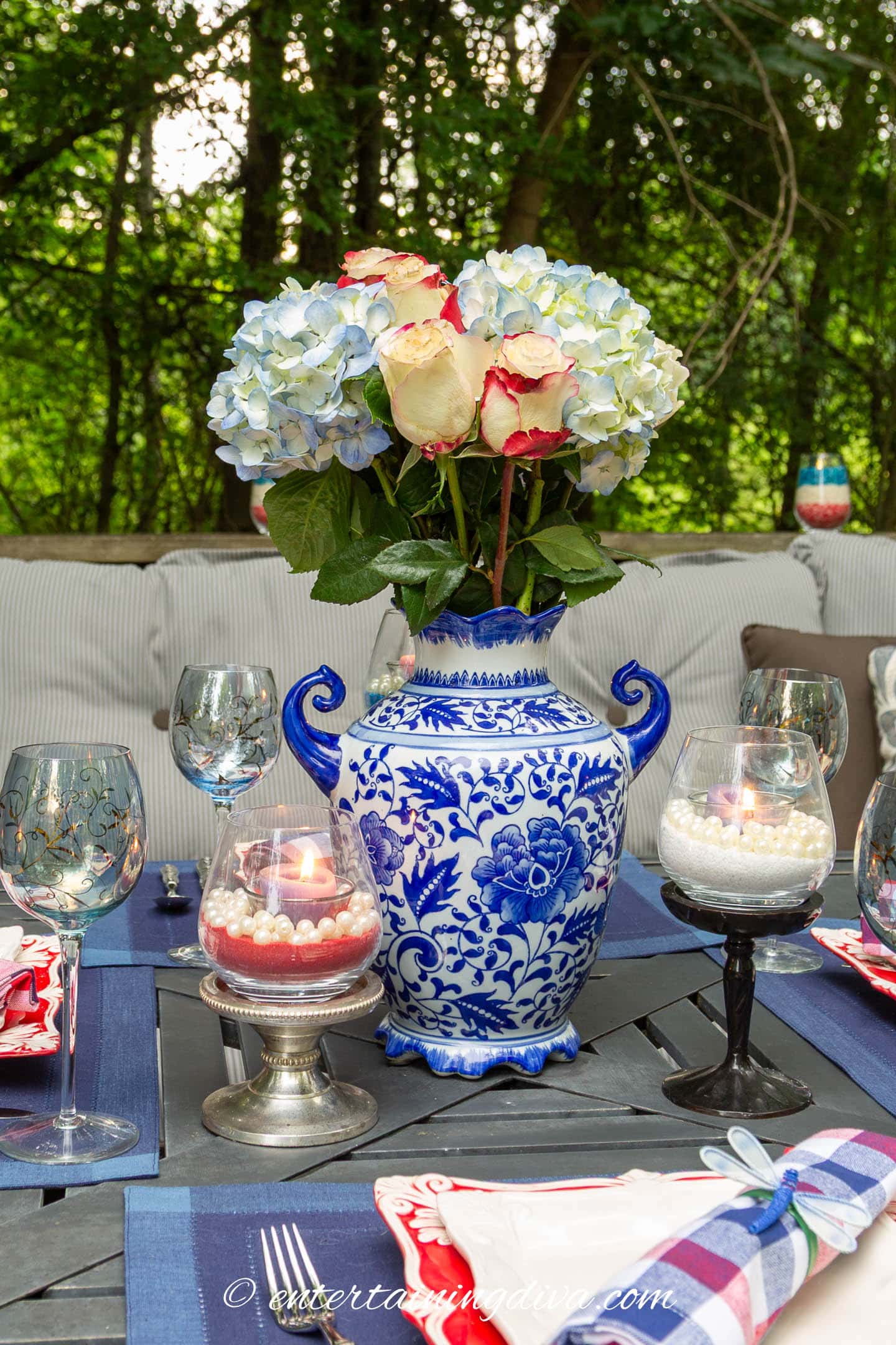 red and white roses with blue hydrangeas in a blue and white vase on a 4th of July table