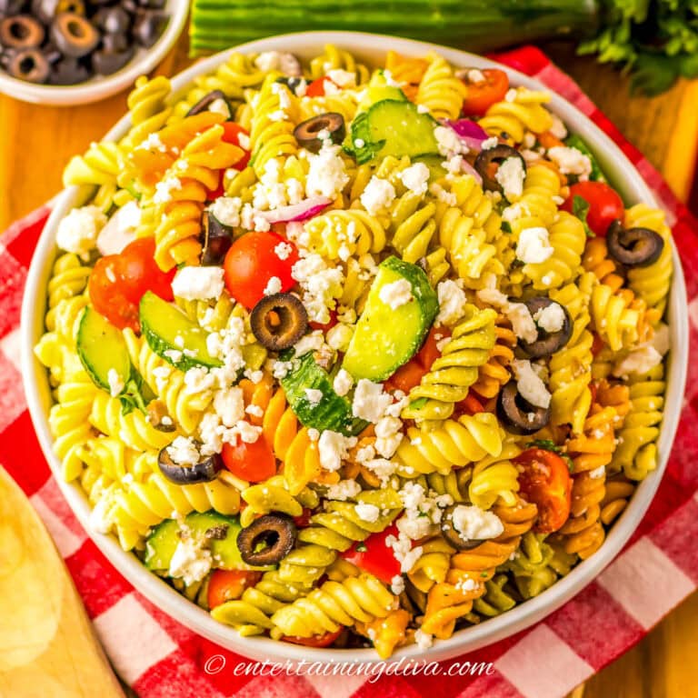 overhead view of a bowl of Greek pasta salad with feta cheese and olives