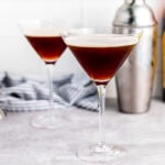 two martini espressos in front of a cocktail shaker