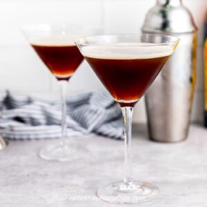 two martini espressos in front of a cocktail shaker