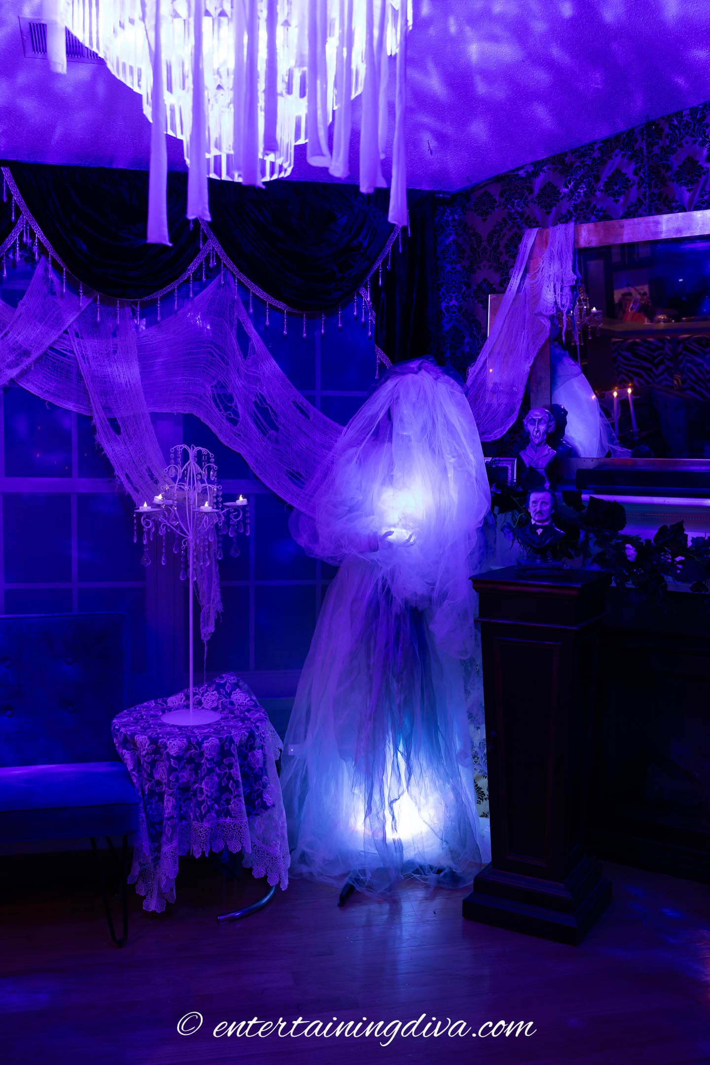 A ghostly bride lit with uplights under her dress