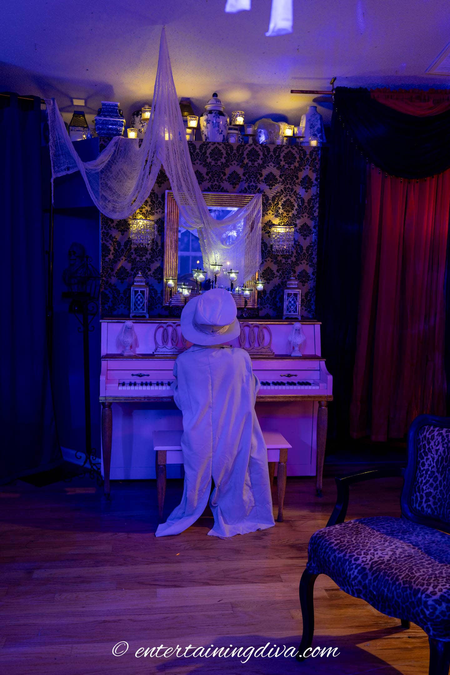A ghostly piano player sitting at a piano with candles above it