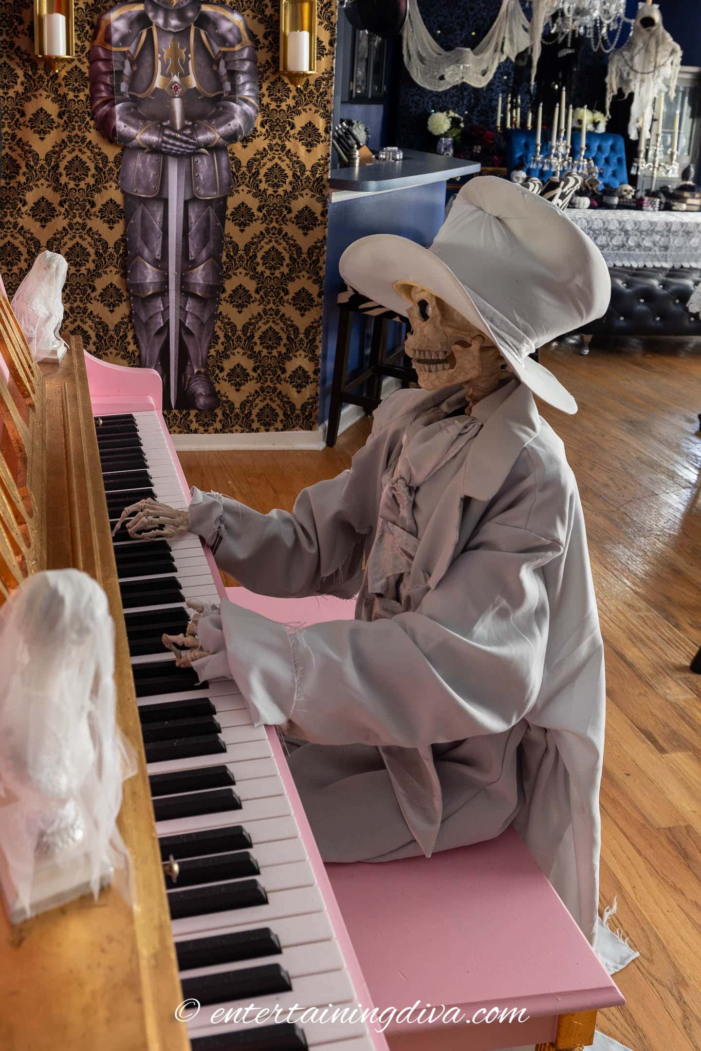 A skeleton piano player seated at a pink piano