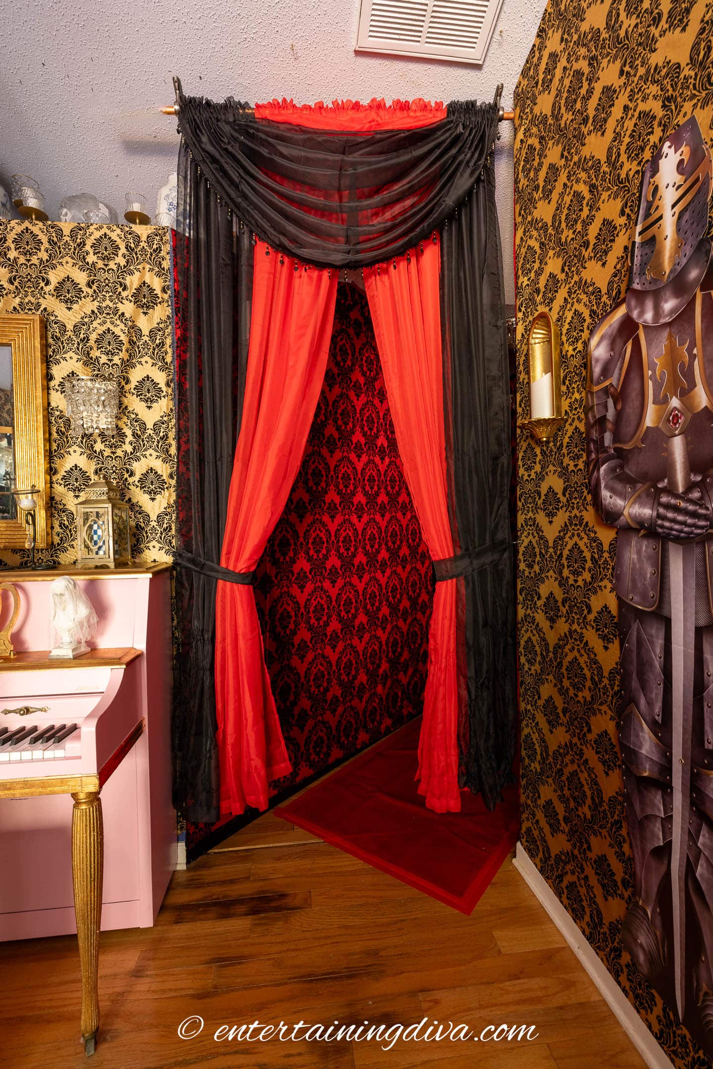 The entrance to the red hallway decorated with red and black curtains