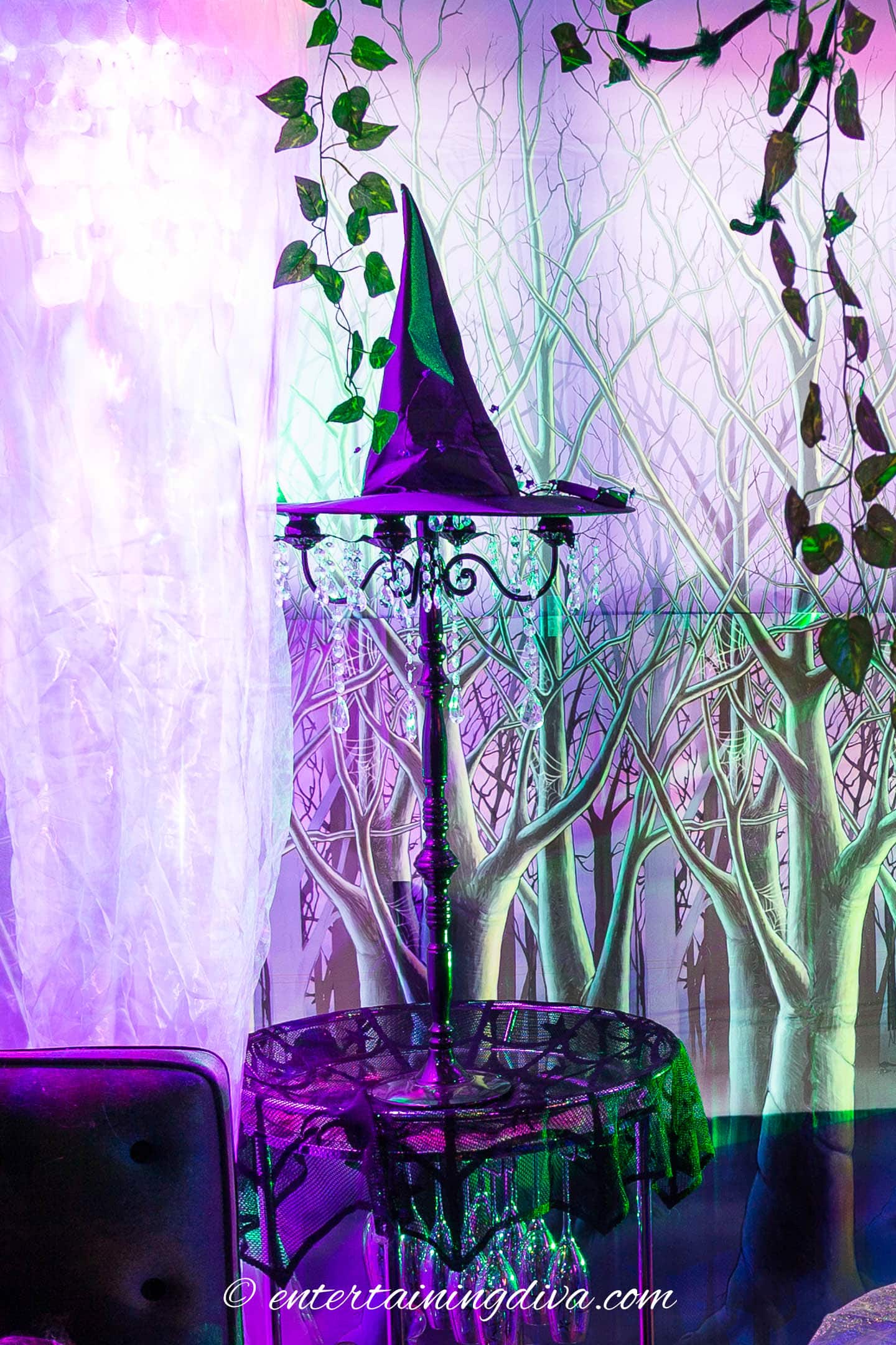 A witch hat on top of a tall candelabra