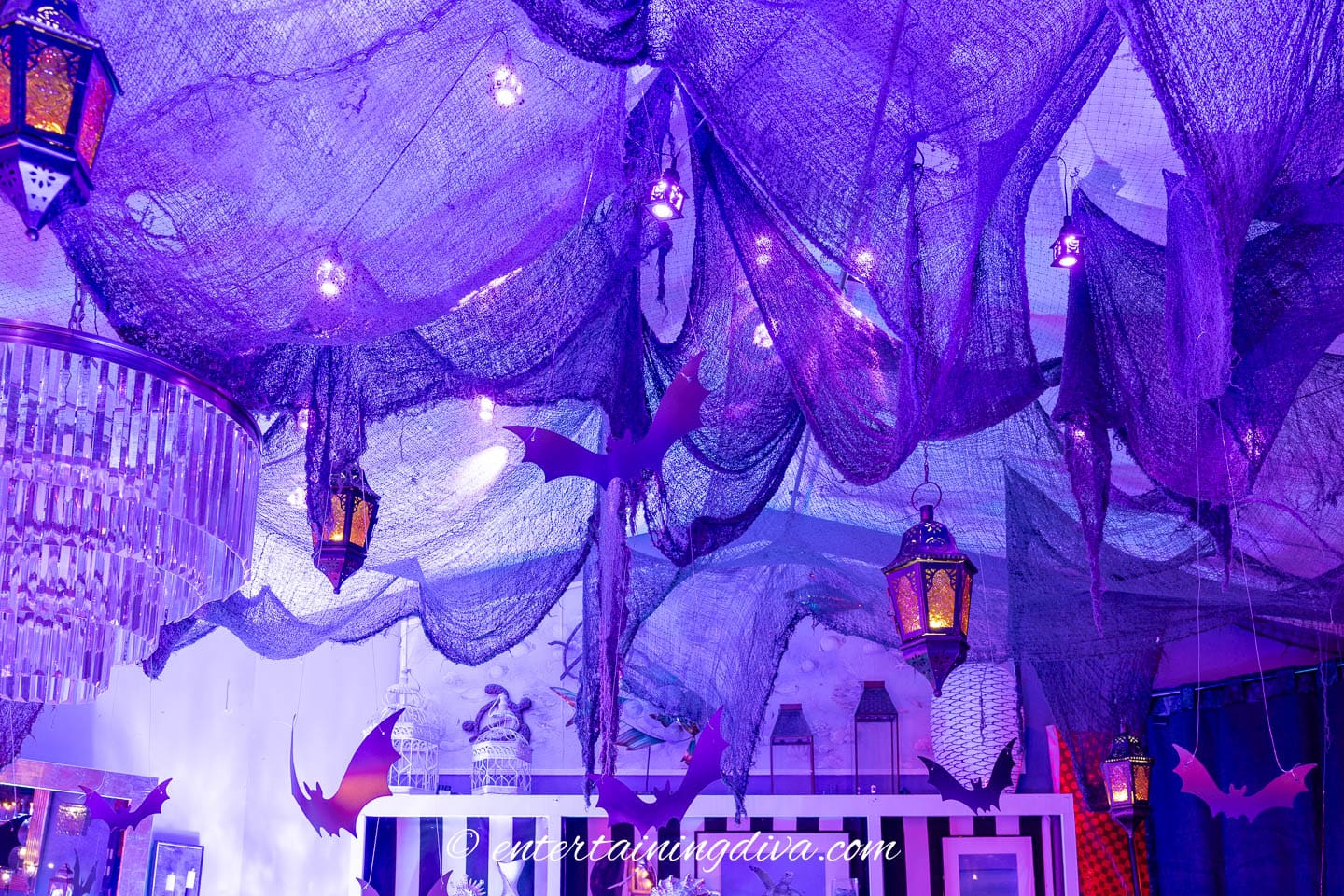 Creepy cloth hung from black mesh stretched across the ceiling