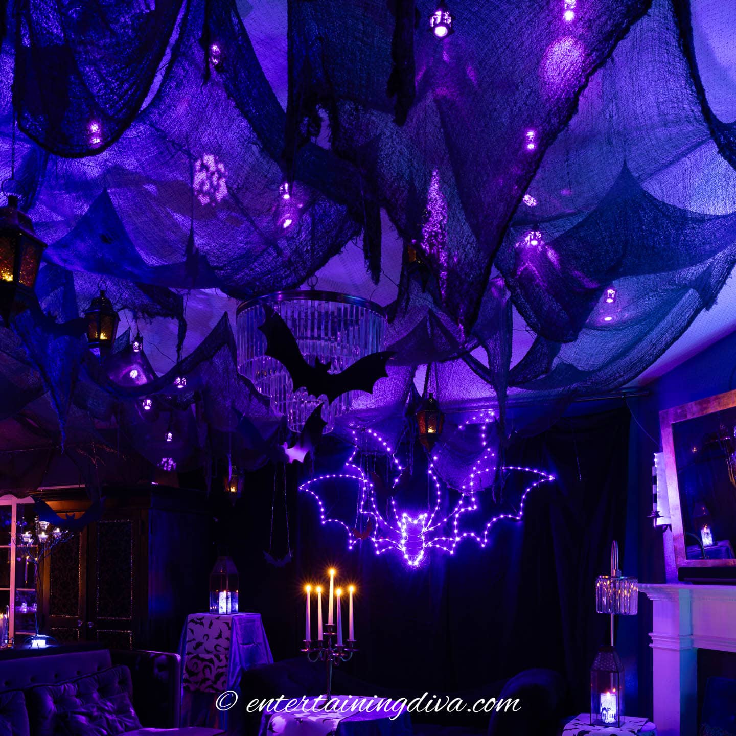 Black creepy cloth hanging from the ceiling in a living room decorated for Halloween