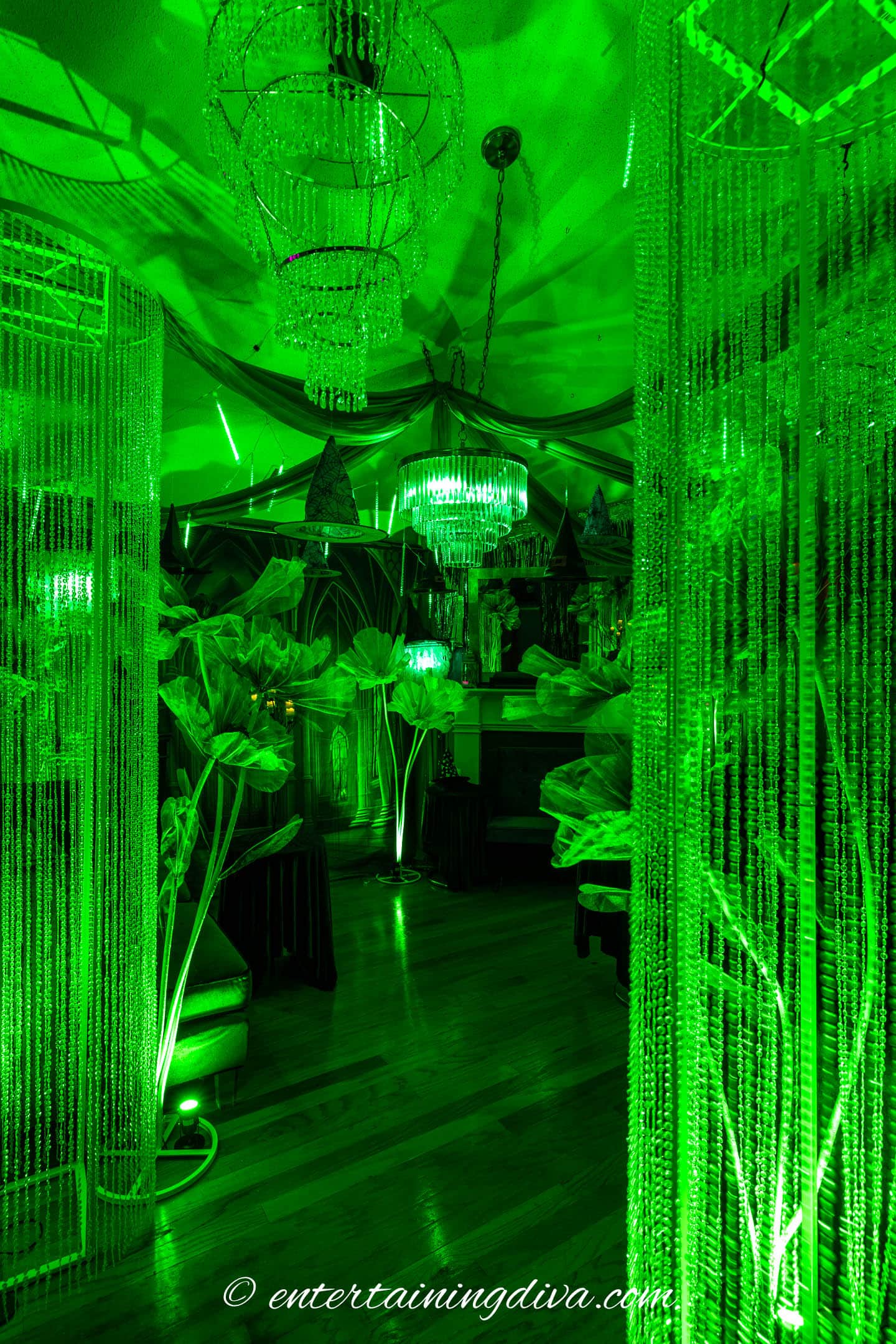 A living room decorated all in green for a Wicked party