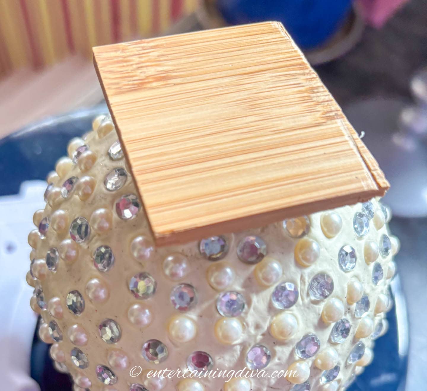 A large ornament with a piece of plywood stuck to it