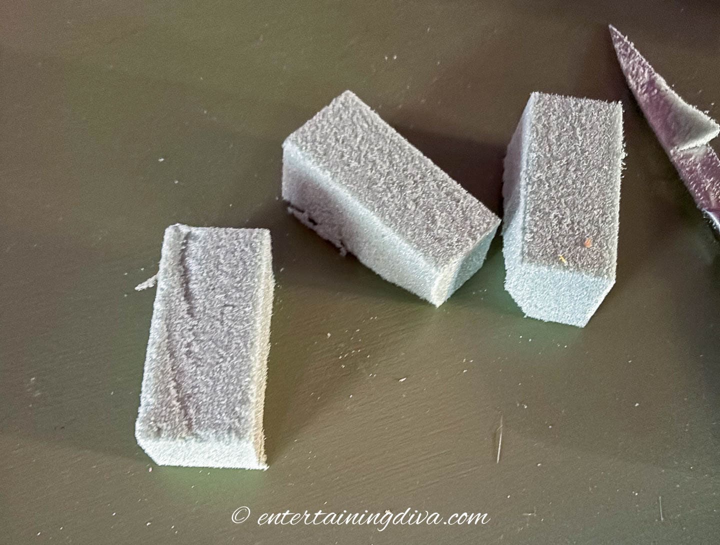 3 small pieces of floral foam on a table
