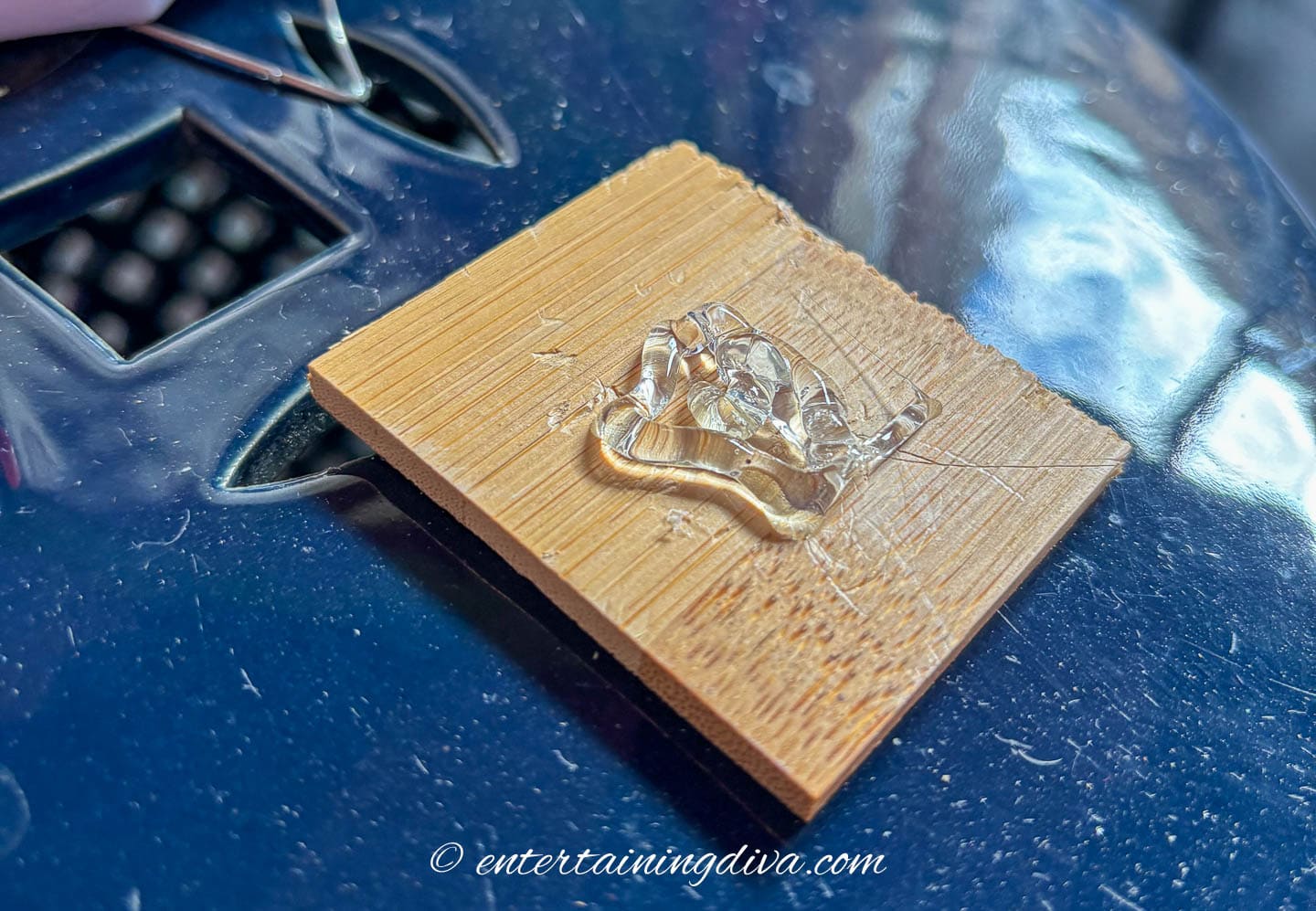 A small piece of wood with hot glue in the middle