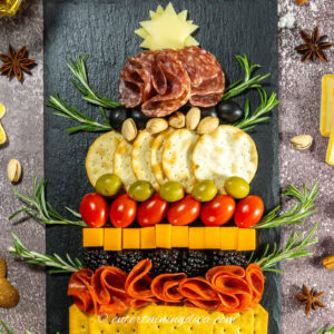 Close up of the top of a Christmas tree charcuterie board with a cheese star topper