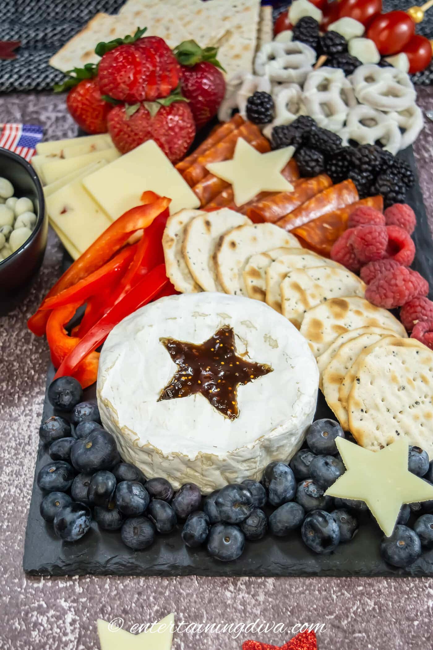 close up of brie with a star cut in the top of it on a 4th of July charcuterie board