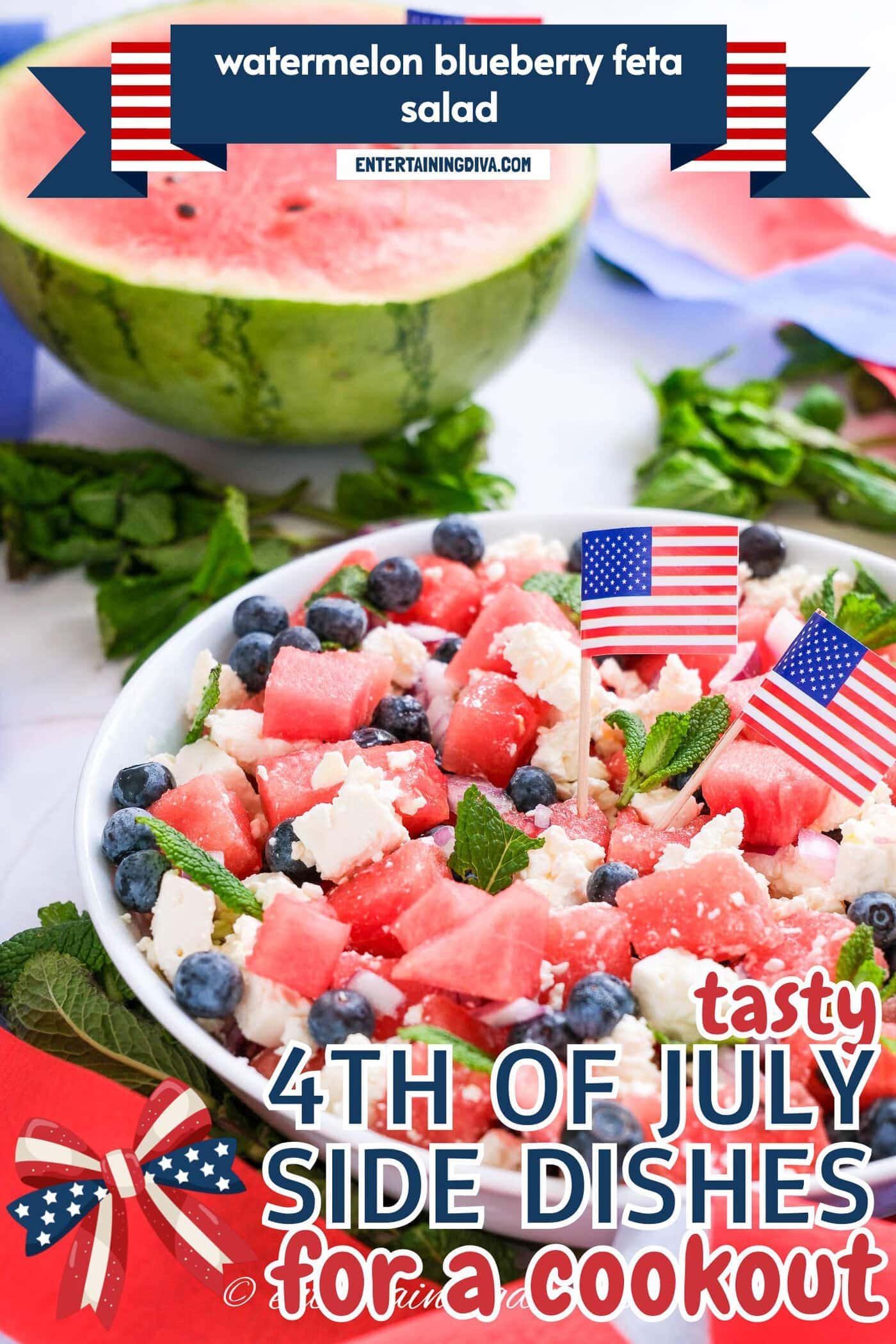 A bowl of watermelon, blueberry, and feta salad garnished with mint and small American flags, with a half watermelon and patriotic decorations in the background.