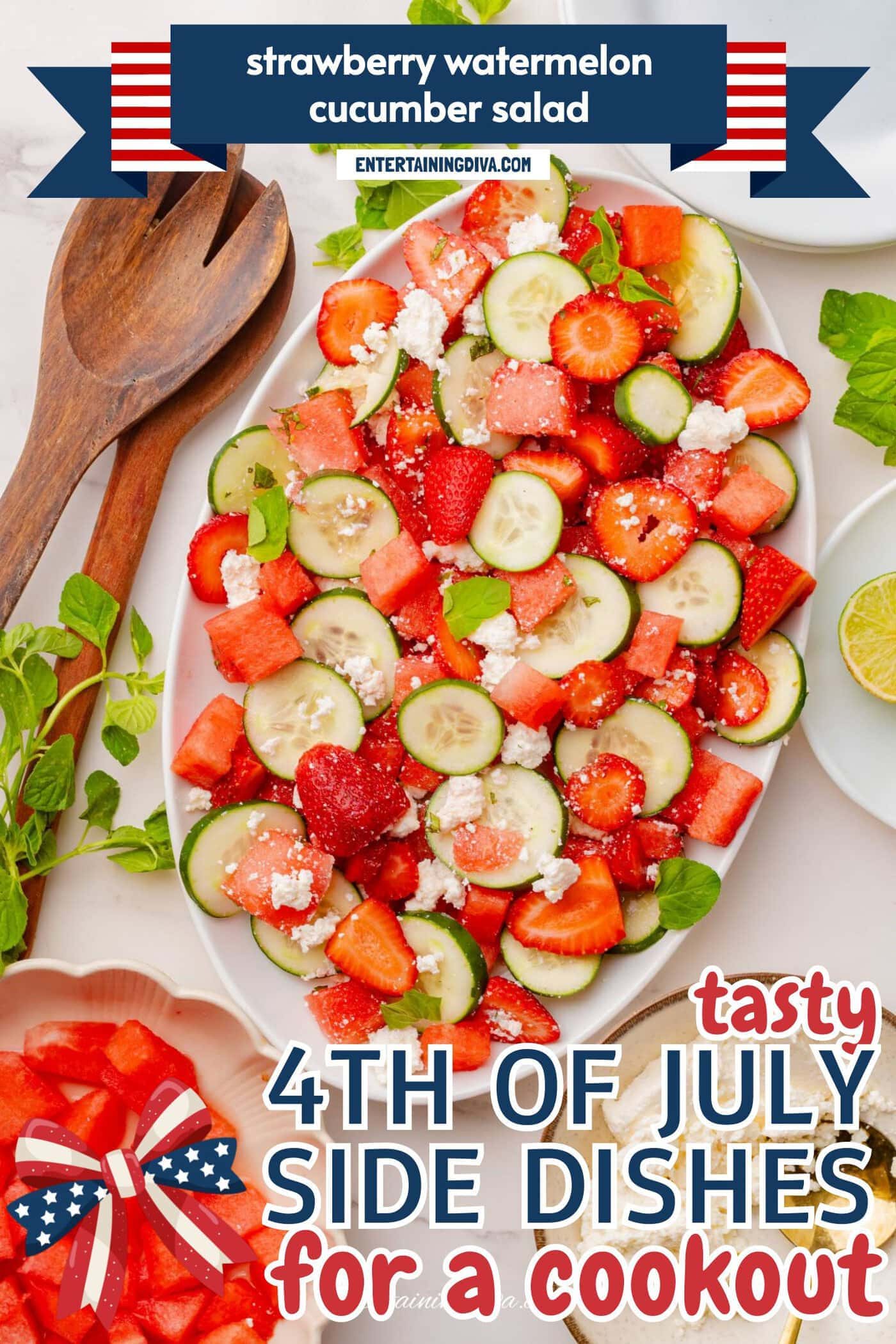 A platter of salad with watermelon, strawberries, cucumber slices, and crumbled feta cheese, surrounded by fresh mint, a bowl of watermelon cubes, and a plate of feta.