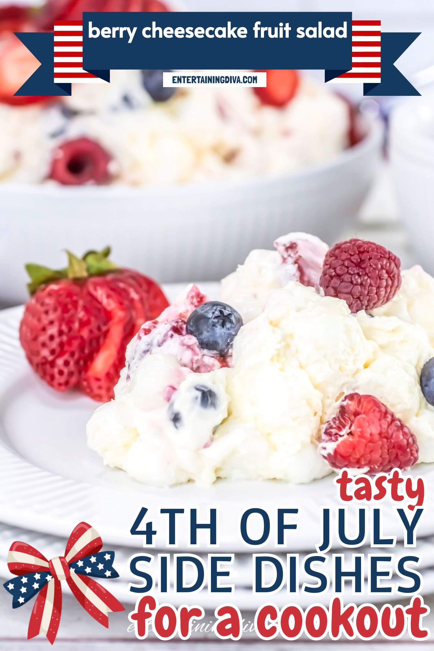 A serving of creamy fruit salad on a white plate, topped with raspberries, blueberries, and strawberries.