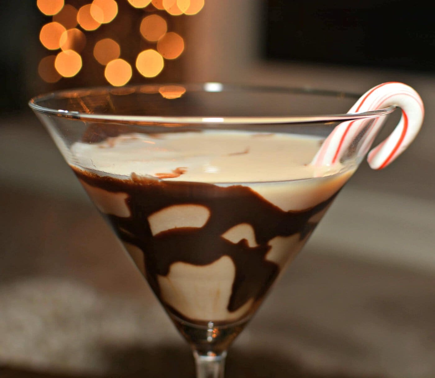 A martini with a candy cane garnish.