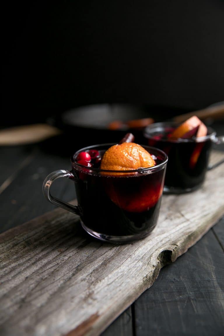 Two glasses of mulled wine on a wooden table.
