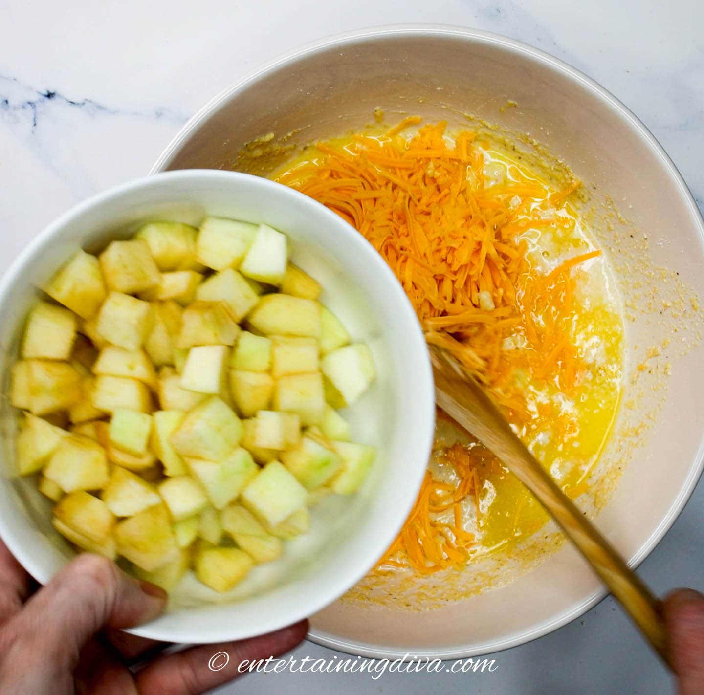 apple in a bowl about to be added to cornbread batter