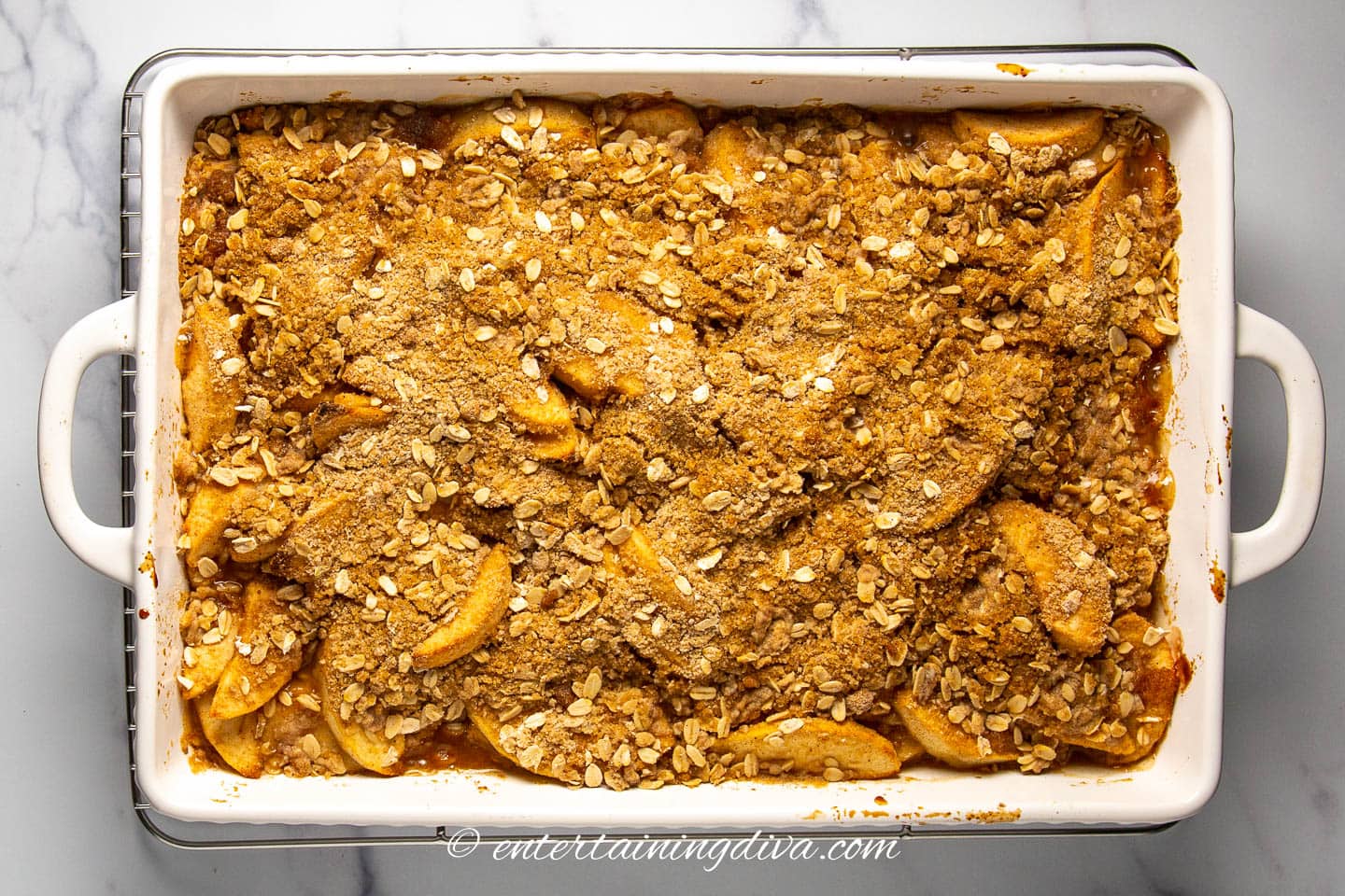 baked apple oat crisp in a rectangular white baking dish