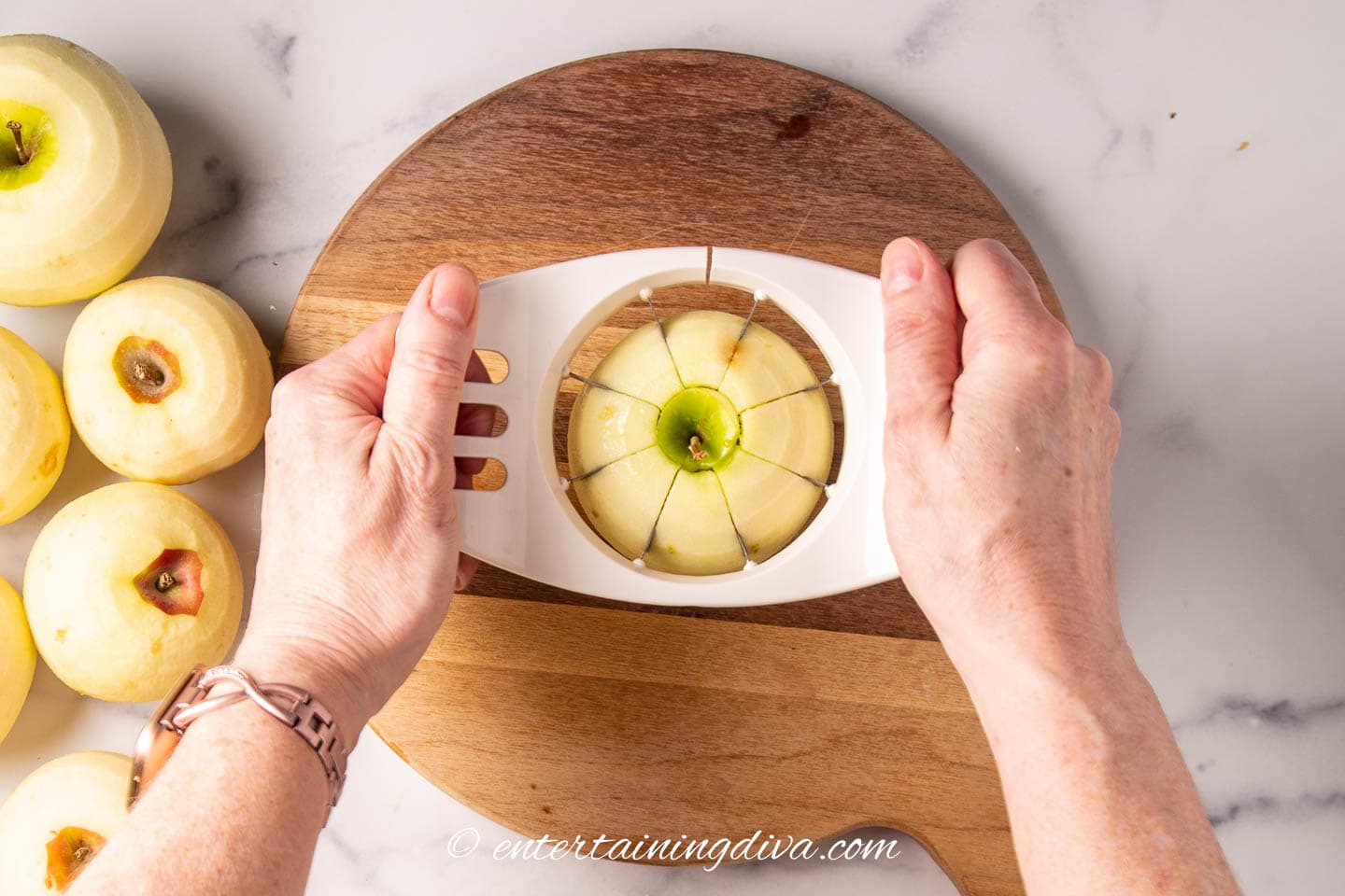apple being cored and sliced with an apple slicer