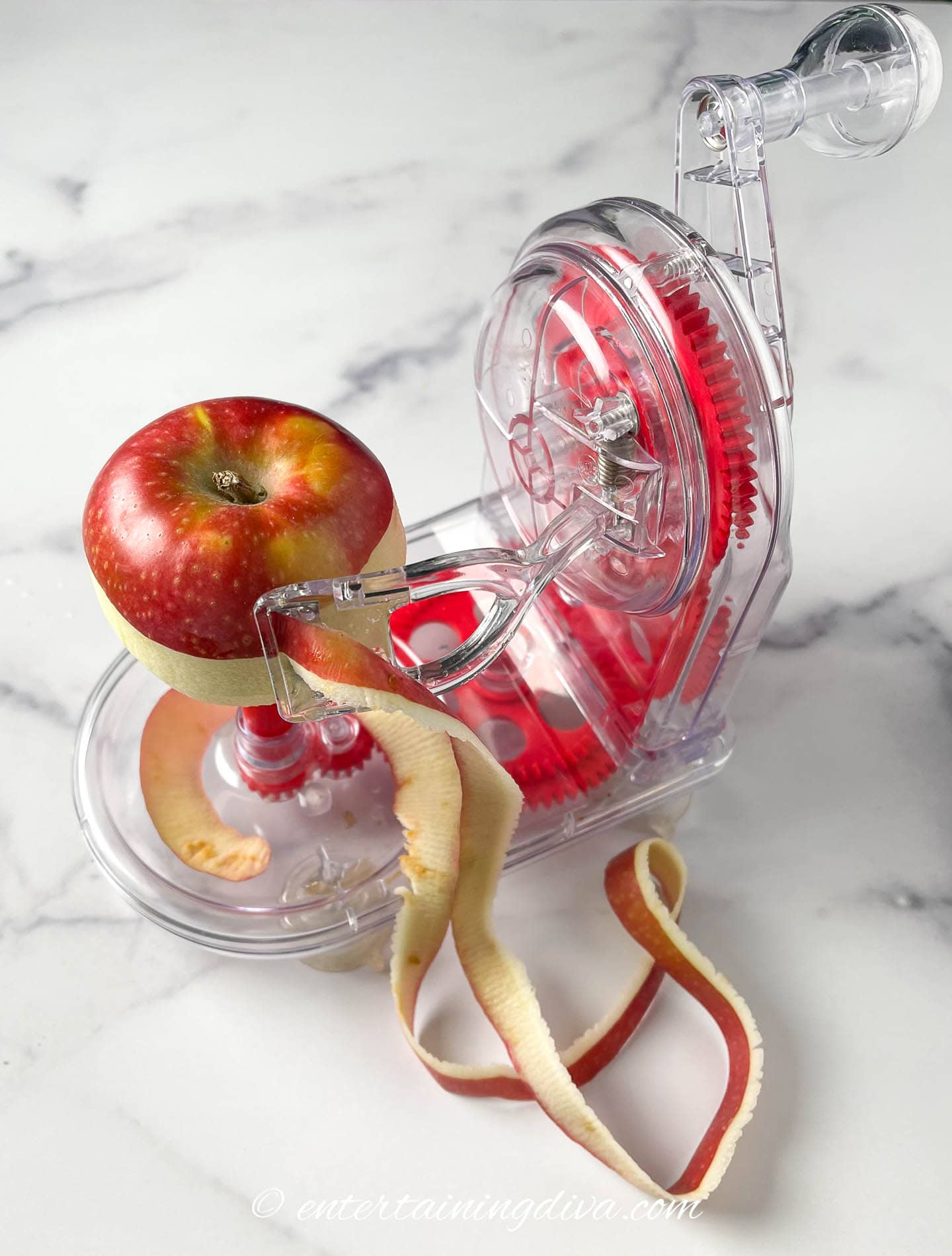 apple being peeled with an apple peeler