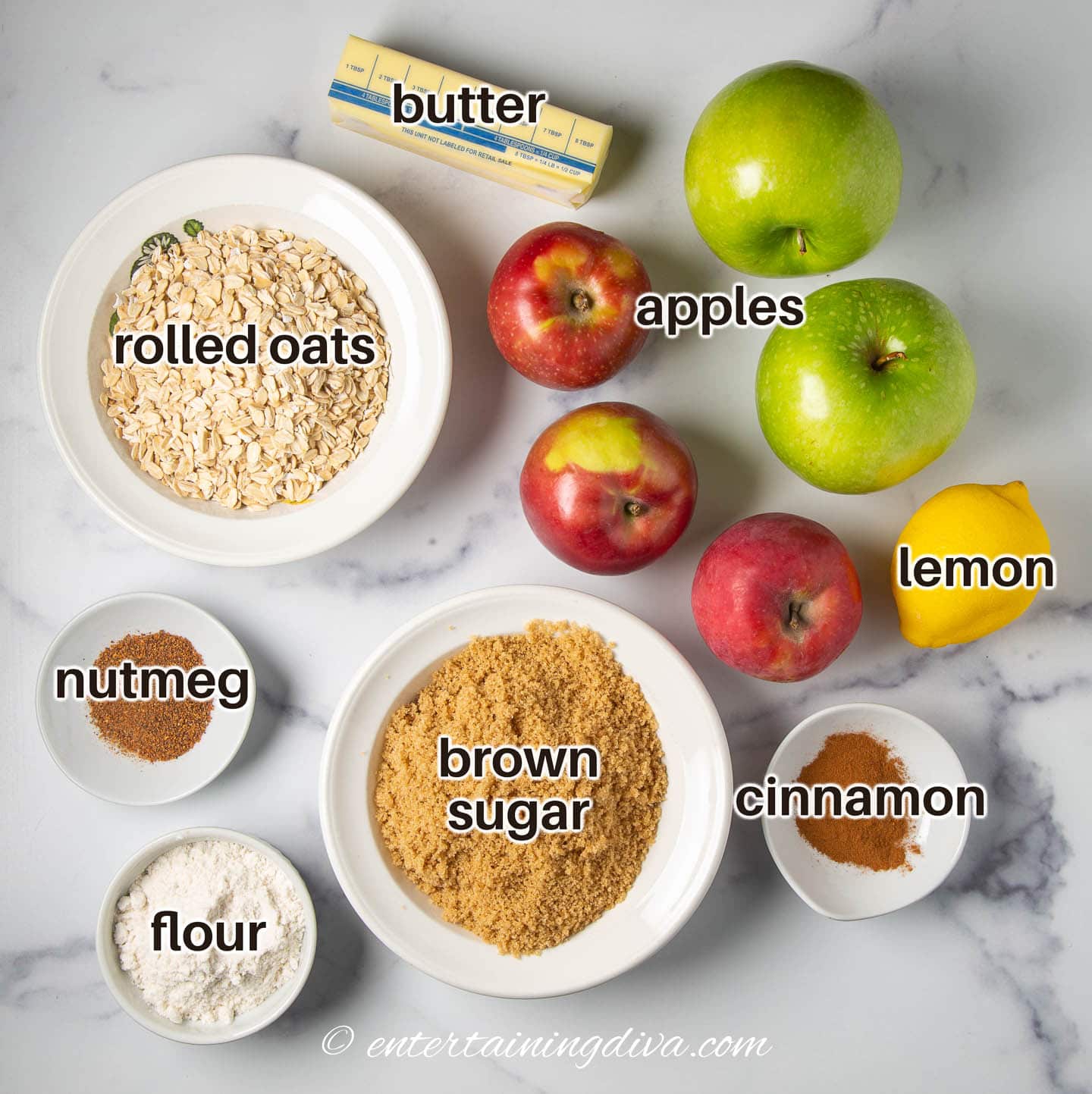 apple crisp ingredients - rolled oats, apples, butter, lemon, brown sugar, cinnamon, nutmeg, flour