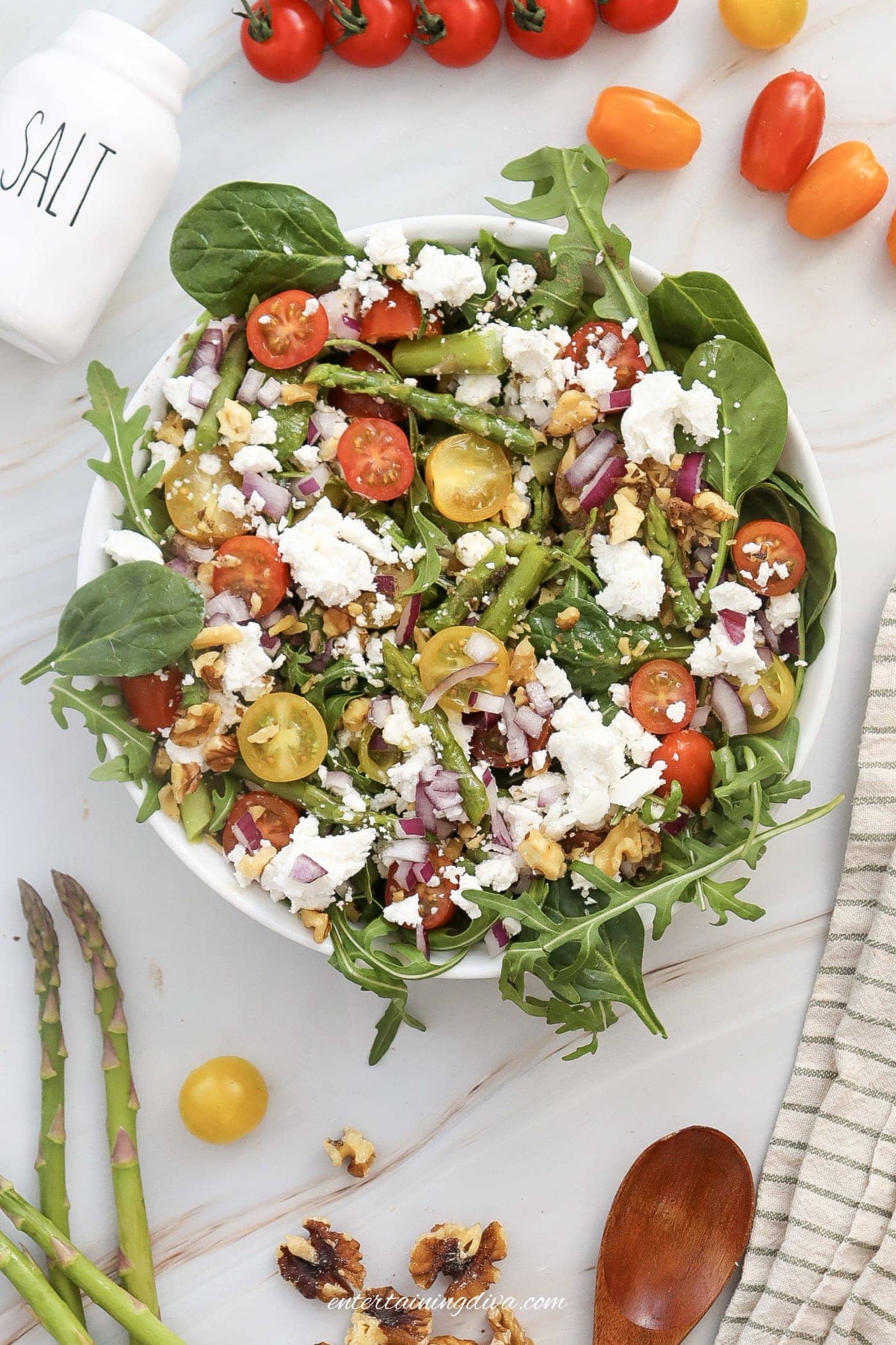 Overhead view of asparagus goat cheese salad in a salad bowl