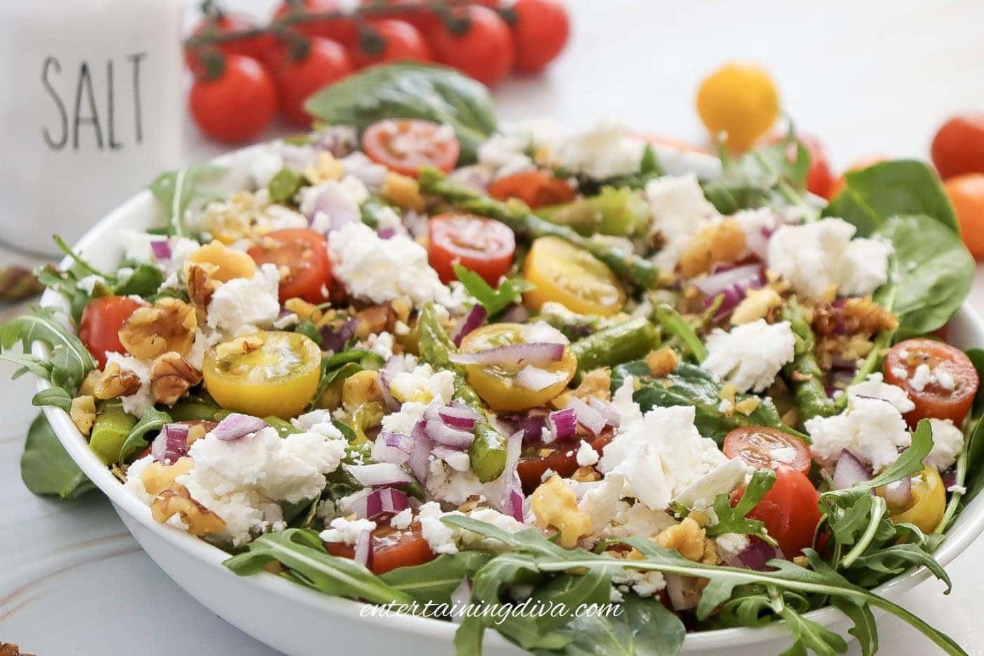 A side view of asparagus goat cheese salad in a bowl