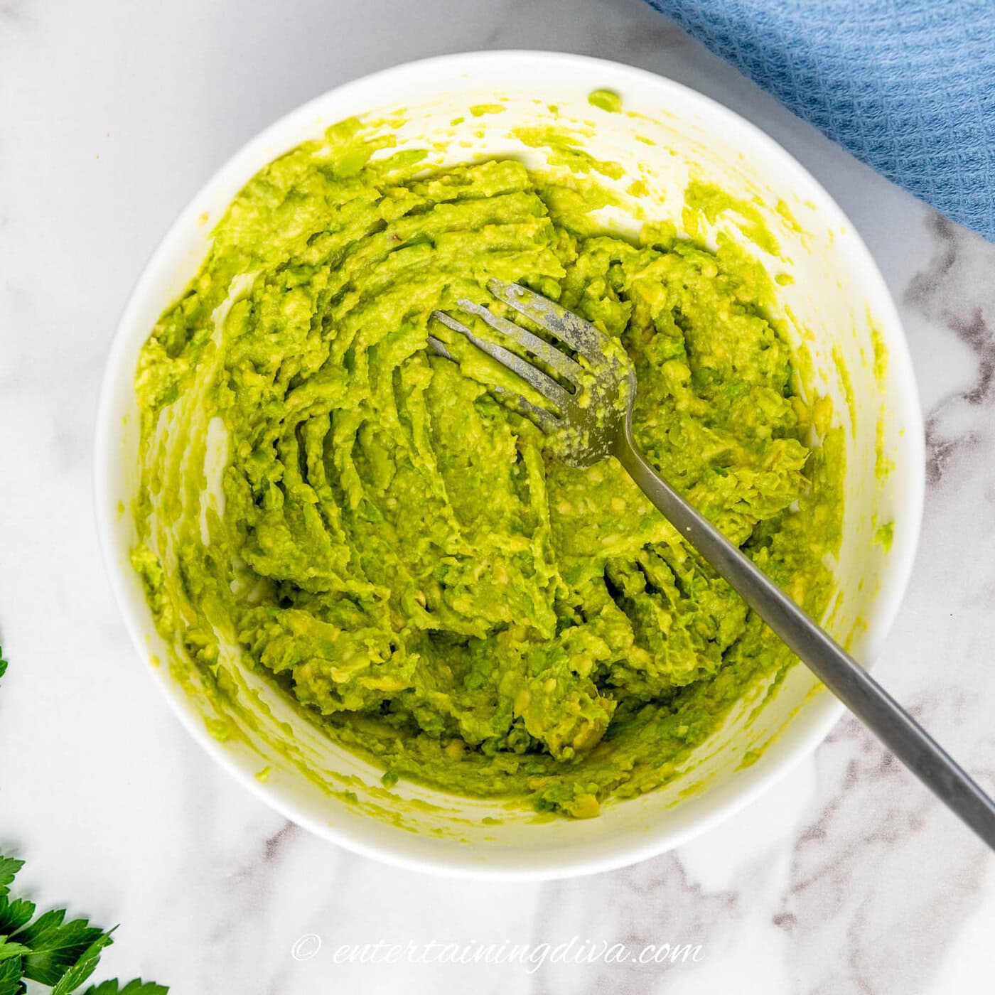 avocado and egg yolks mashed together in a bowl