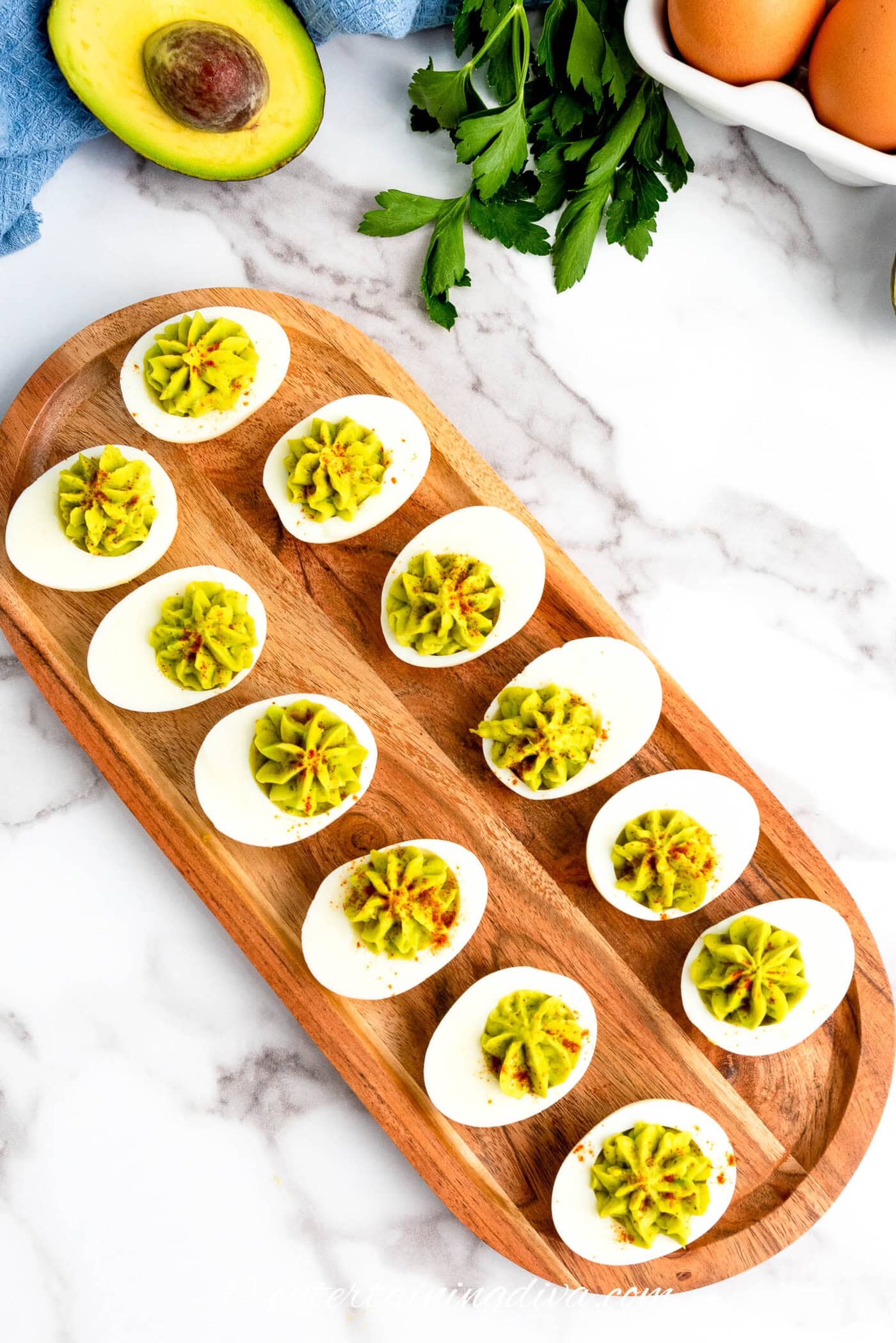 overhead picture of avocado deviled eggs on a tray