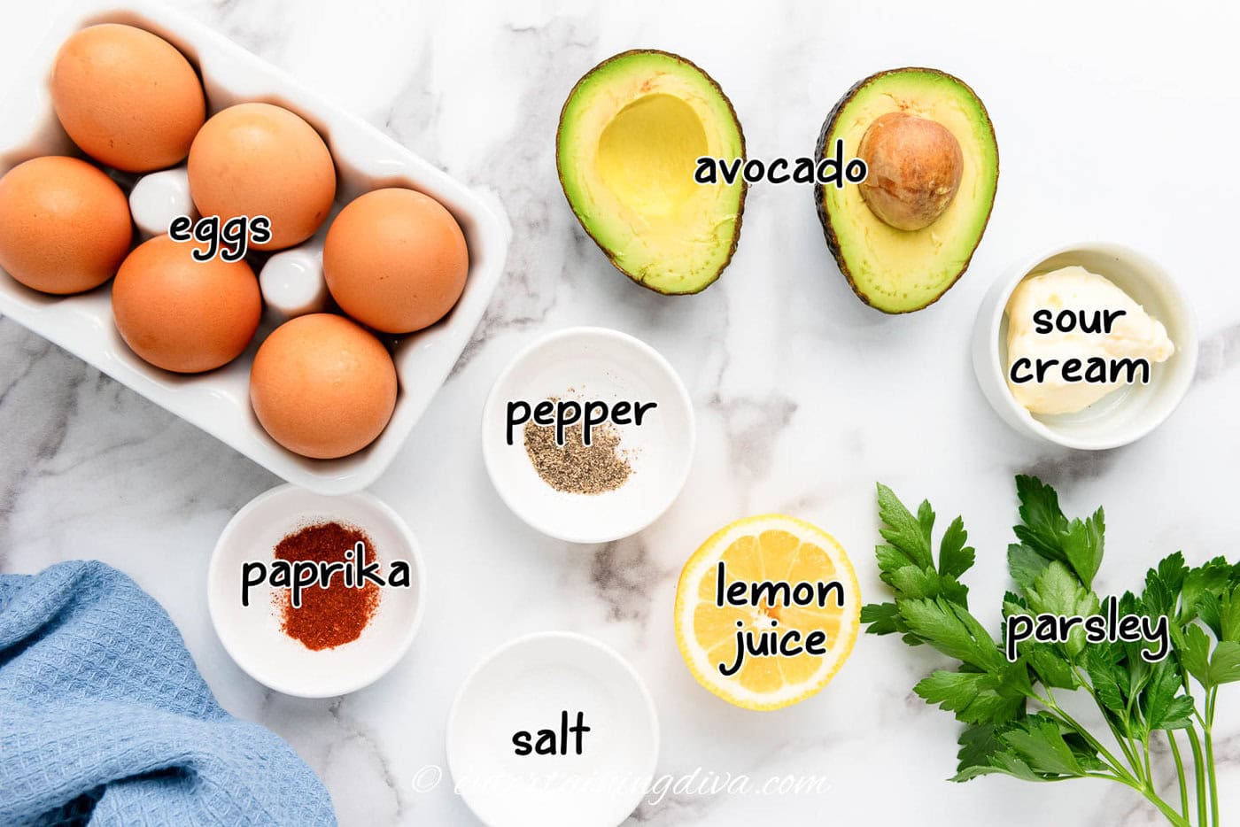 Avocado deviled eggs ingredients - eggs, avocado, sour cream, lemon, pepper, salt, paprika