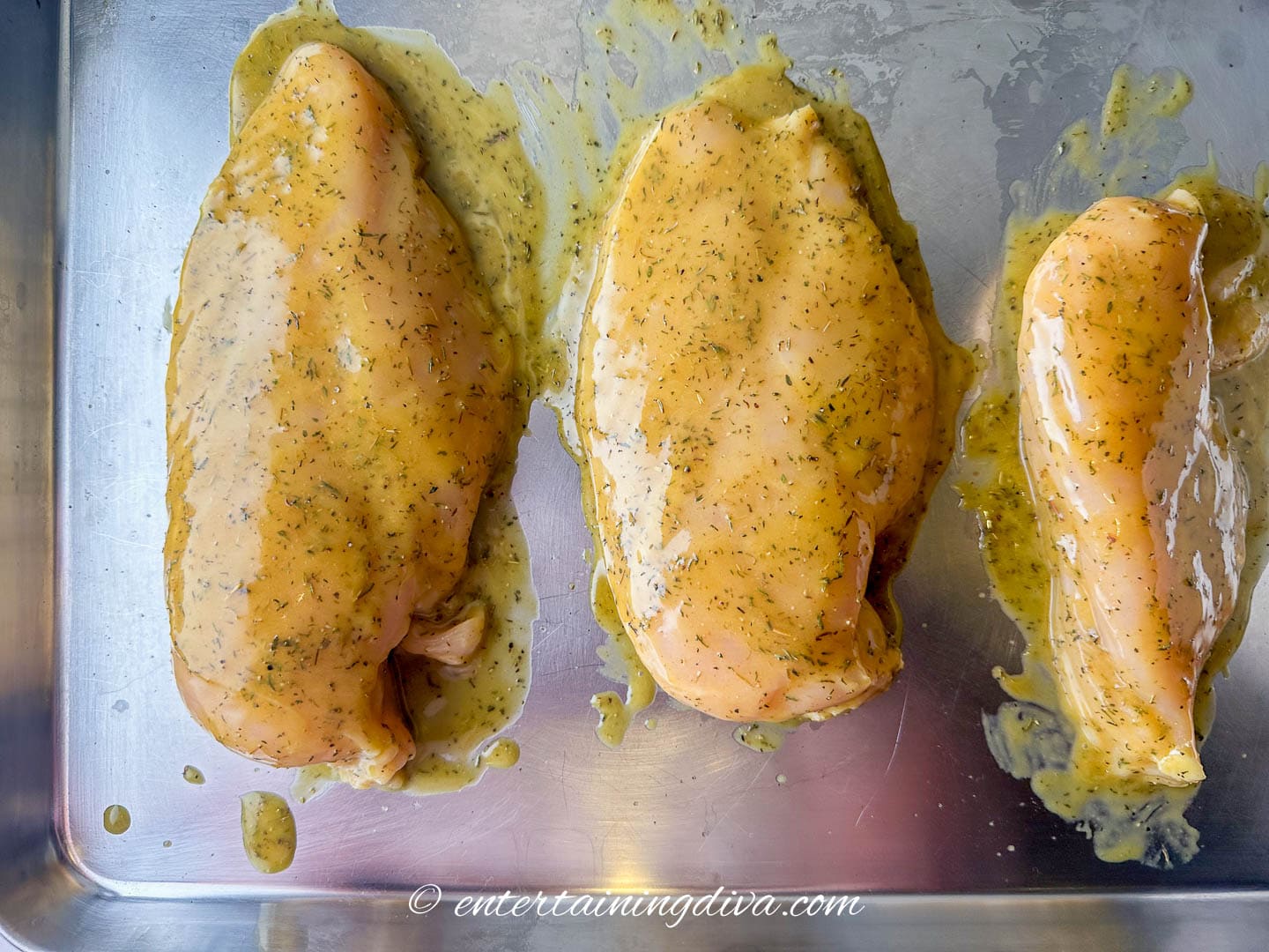 honey mustard chicken breasts on a baking sheet before going in the oven