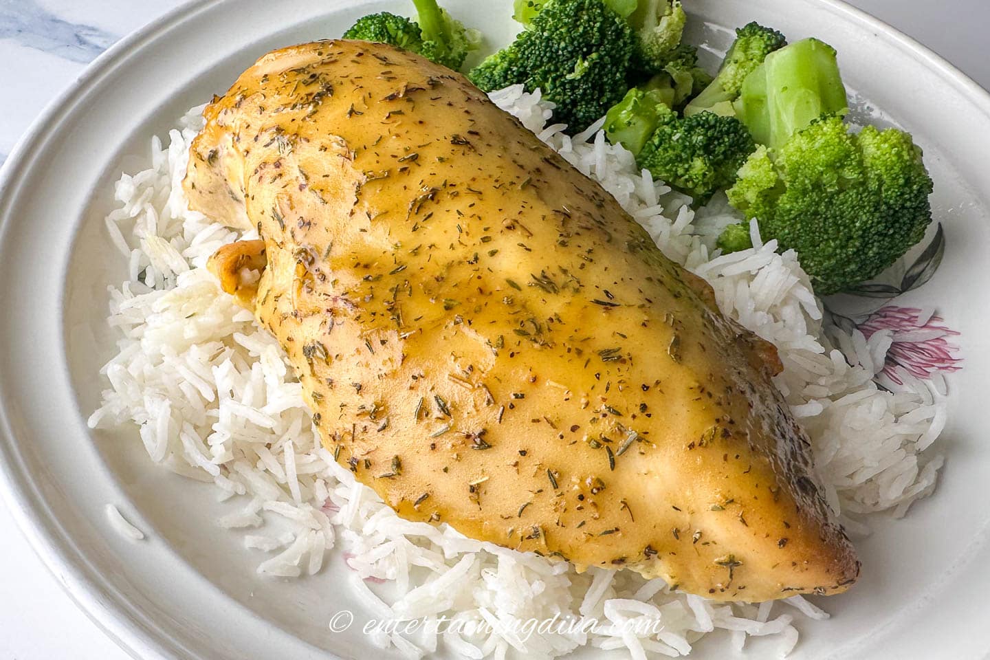 baked chicken breast with honey mustard sauce on a plate with rice and broccoli