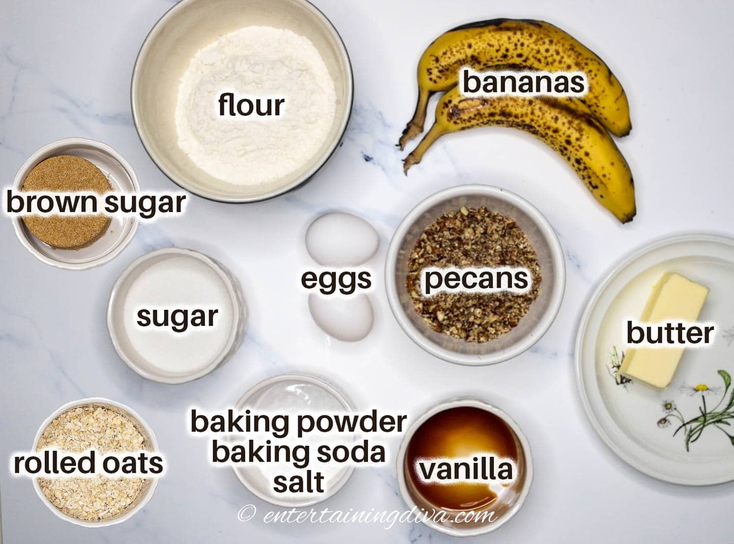 banana nut bread with streusel ingredients - bananas, pecans, flour, eggs, brown sugar, sugar, rolled oats, baking powder, baking soda, salt, vanilla and butter