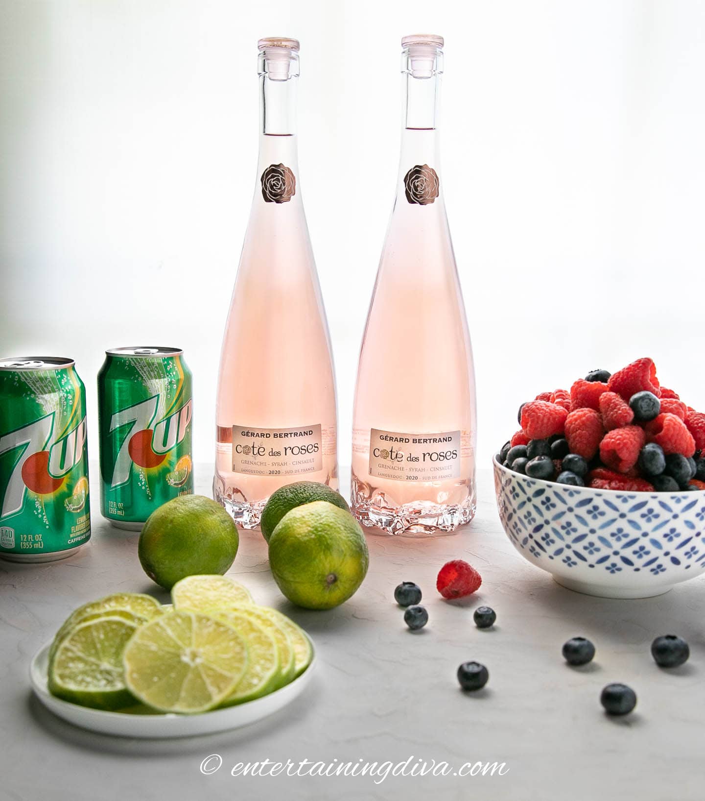 Berries and lime sangria ingredients - rose wine, strawberries, blueberries, raspberries, limes and 7 Up