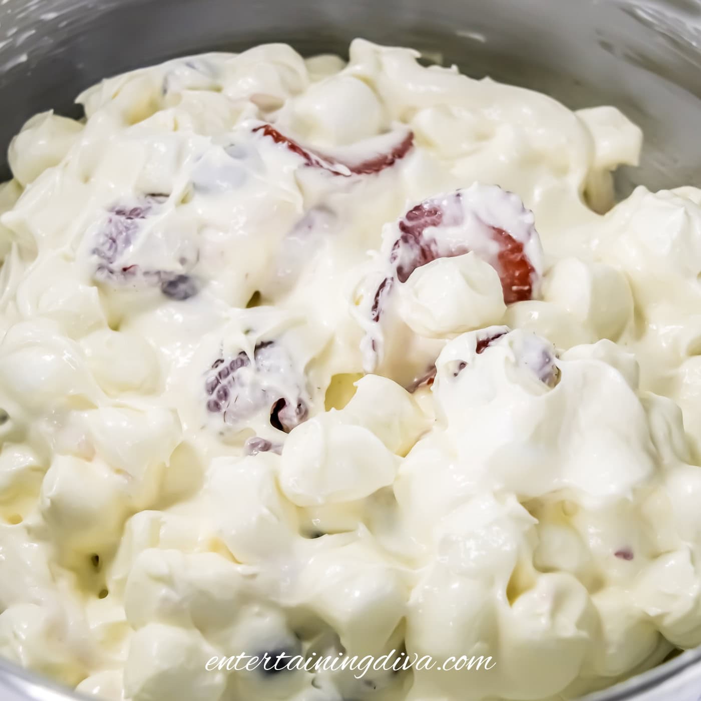 A close-up of berry cheesecake fruit salad.
