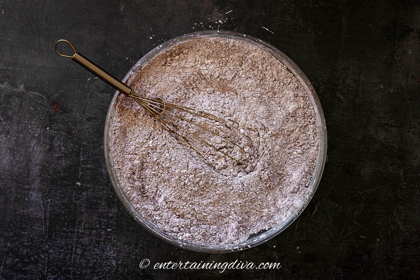 cocoa powder, icing sugar and salt mixed in a bowl with a whisk