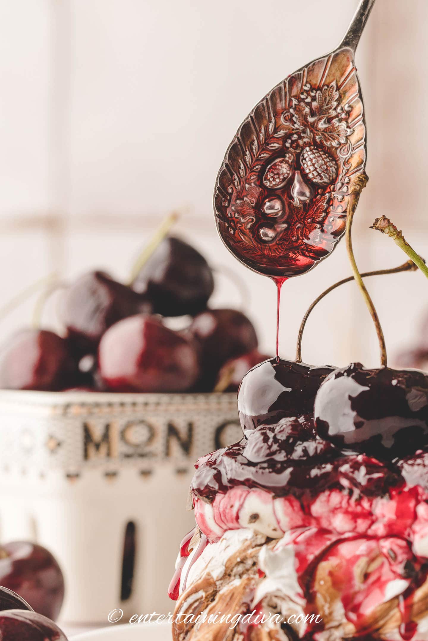 Cherry syrup being drizzled over the top of a black forest mini pavlova