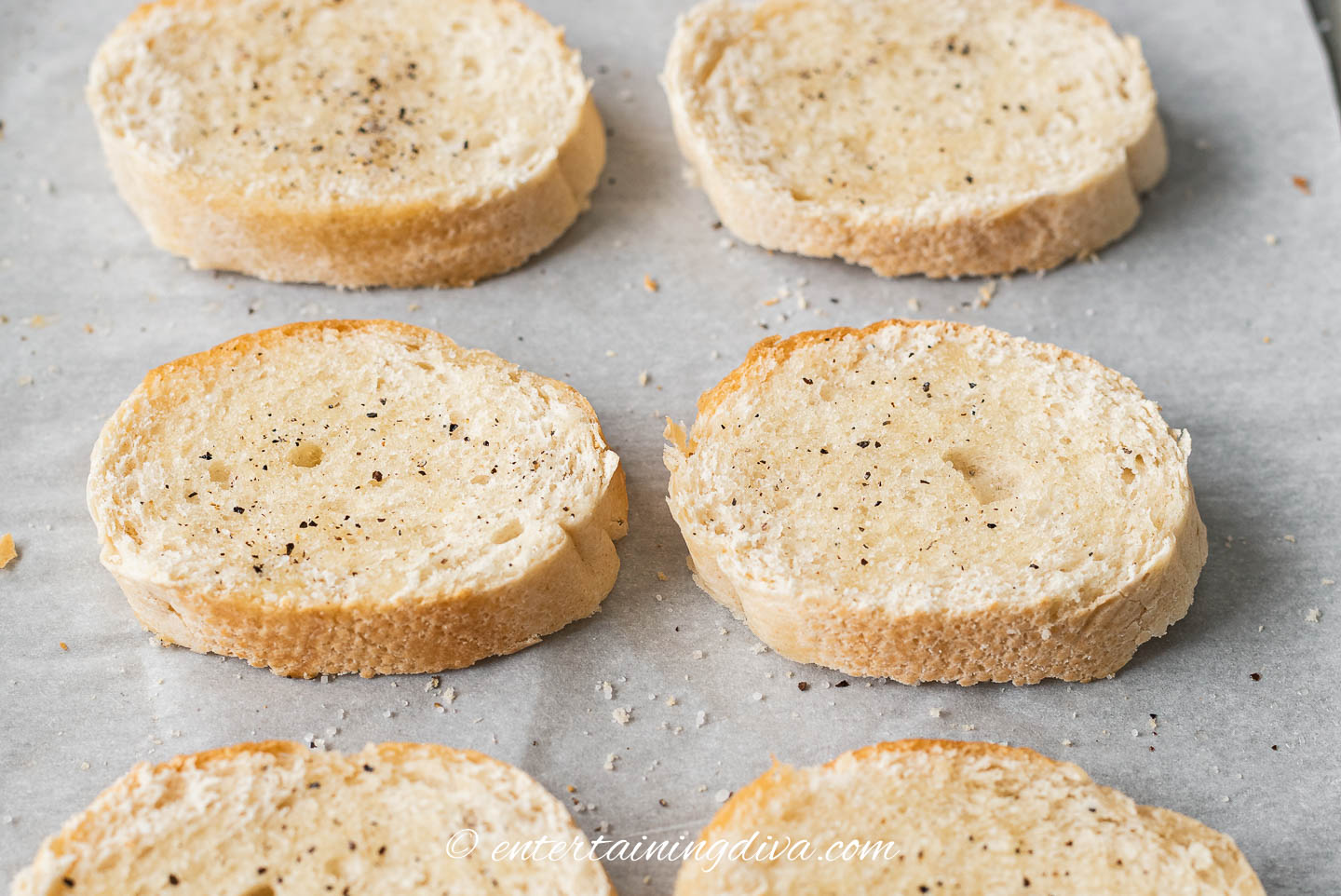 toasted crostini on a baking sheet