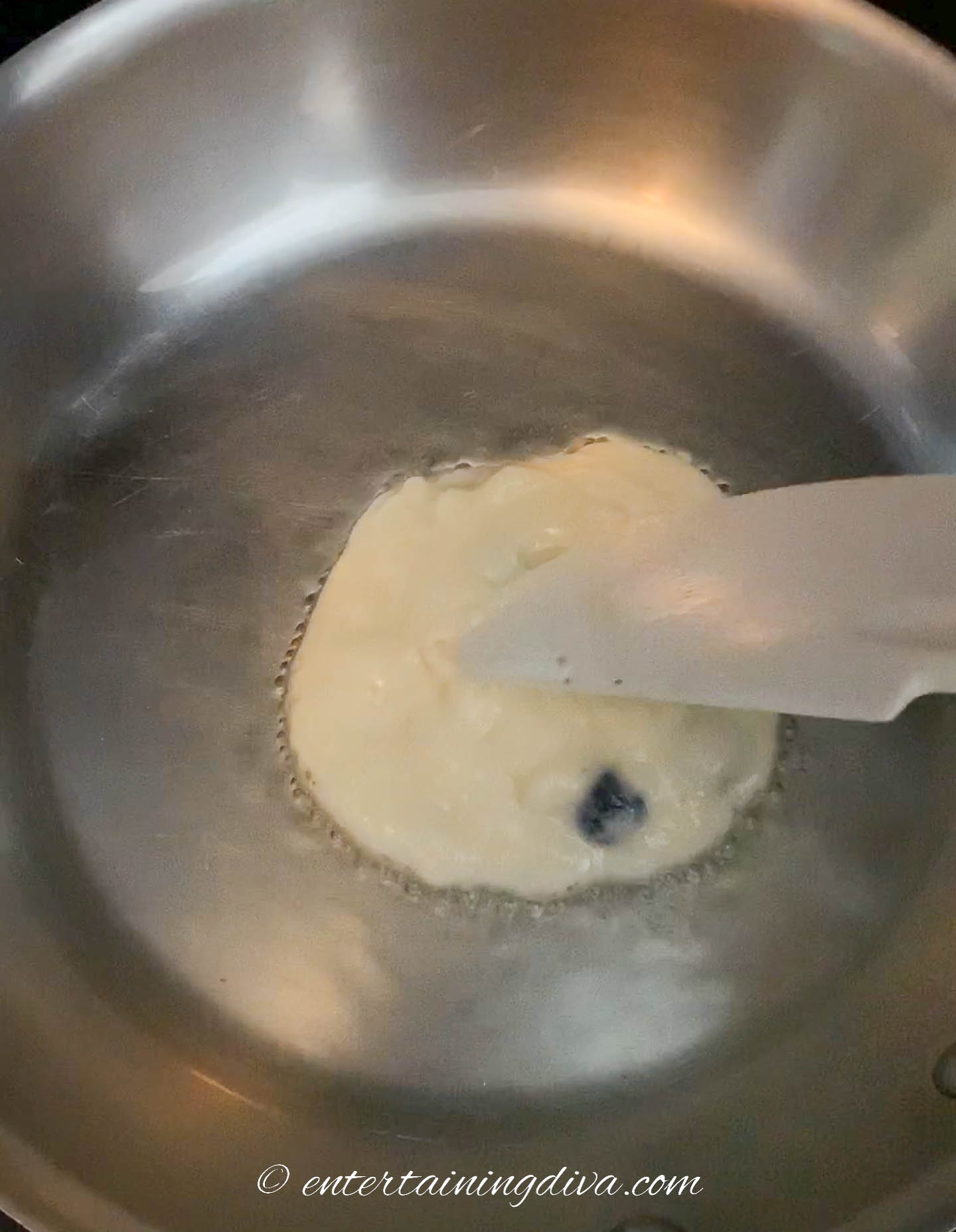 Spatula evening the batter out in the pan