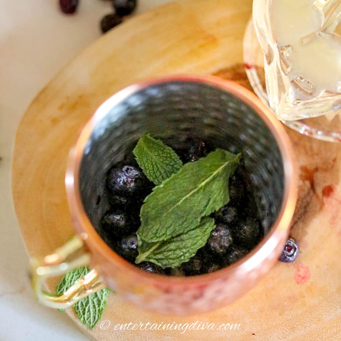 blueberries and fresh mint in a copper mug