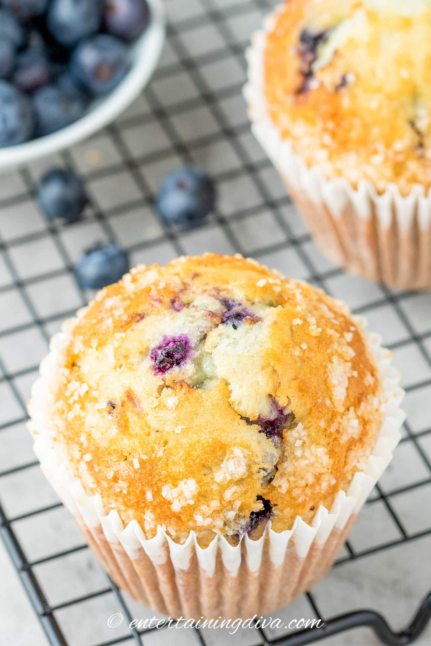 a homemade blueberry muffin on a cooling rack