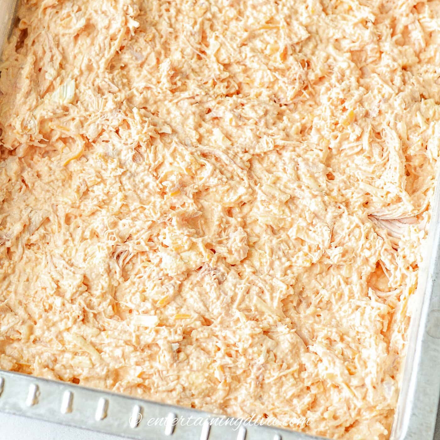 mixed buffalo chicken dip spread out in a pan