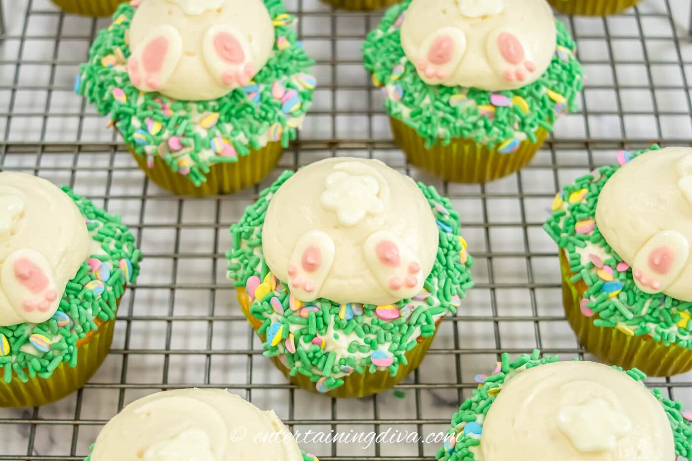 bunny bum cupcakes on a wire cooling rack