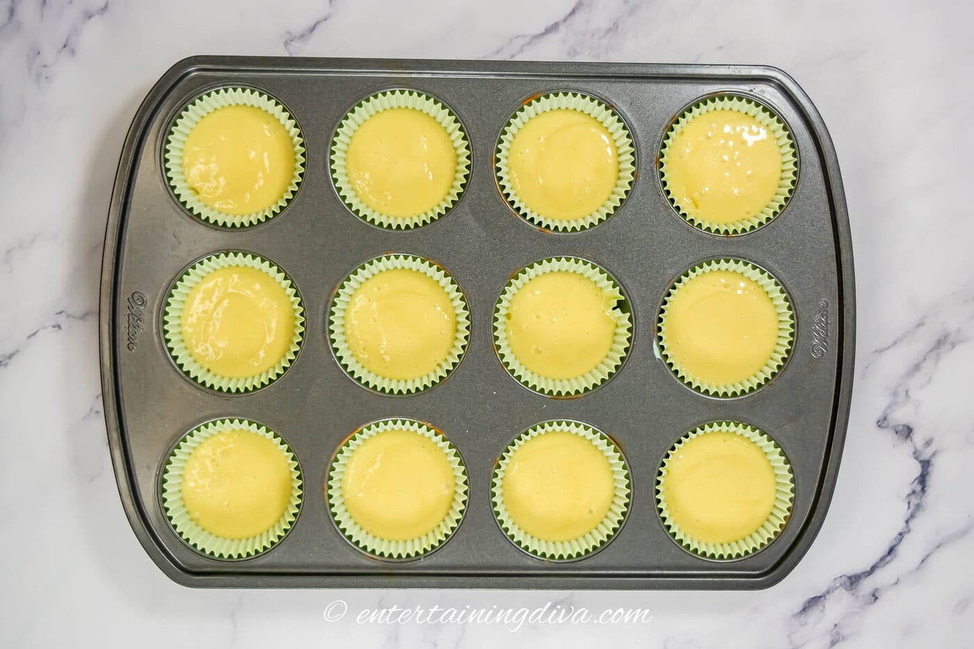 white cake cupcakes in a muffin tin